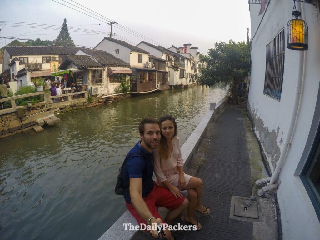 Couple posant le long du canal de Pingjiang Road avec l’architecture traditionnelle de Suzhou en arrière-plan