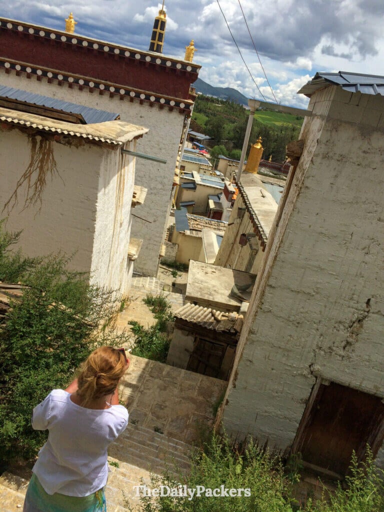 Un visiteur photographie les ruelles sur les toits du monastère de Songzanlin, Shangri-La, Yunnan.