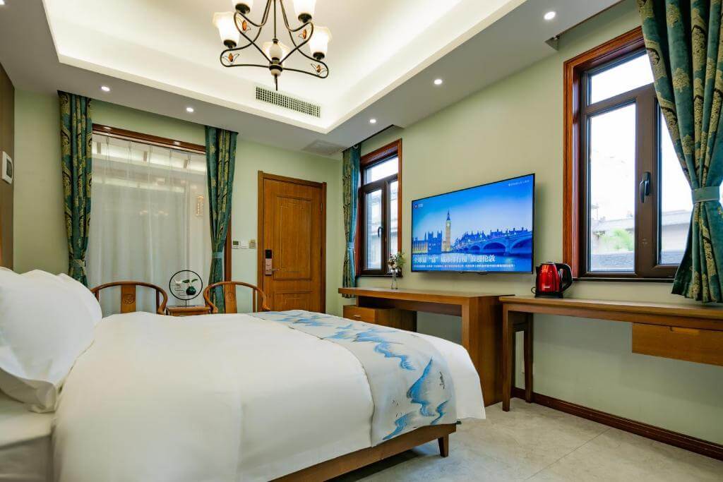 Chambre d’hôtes cosy aux tons verts avec vue sur la ville au Fanjian Inn, Xi’an